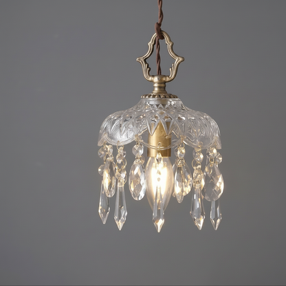 Decorative pendant light with crystal accents on a gray background